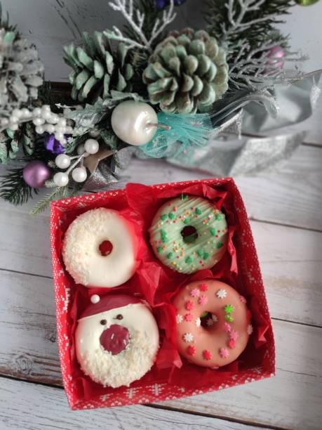 istock unpacking a christmas donut box, donuts with icing and sprinkles 1358053020