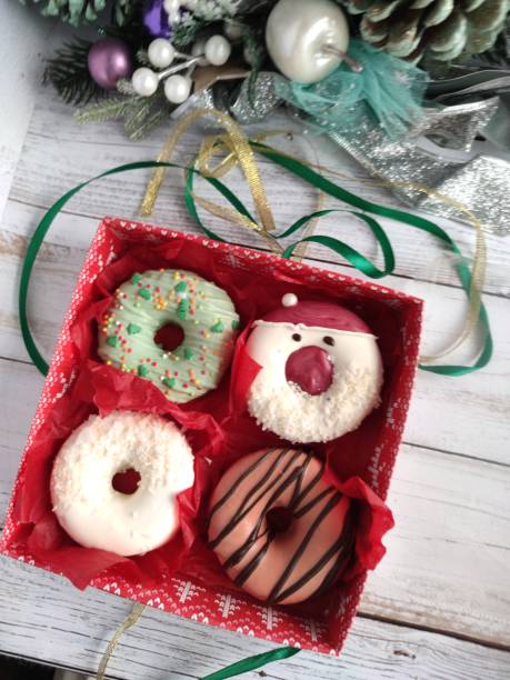 istock unpacking a christmas donut box, donuts with icing and sprinkles 1358053026