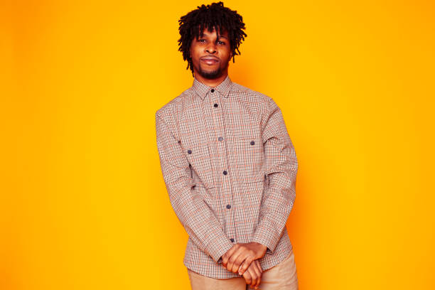 istock young handsome african american guy student posing cheerful and gesturing on yellow background, lifestyle people concept 1358053645
