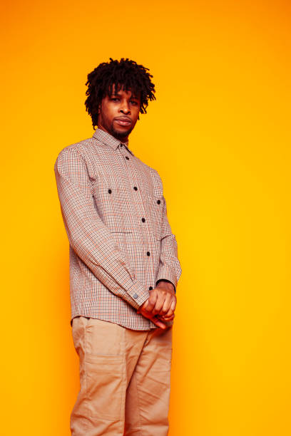 istock young handsome african american guy student posing cheerful and gesturing on yellow background, lifestyle people concept 1358053673