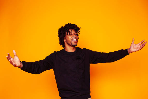 istock young handsome african american guy student posing cheerful and gesturing on yellow background, lifestyle people concept 1358053713