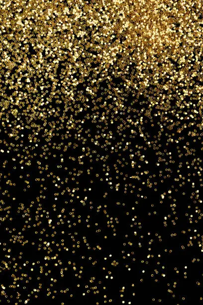 Photo of Gold glitter confetti background, luxury New Year party backdrop.