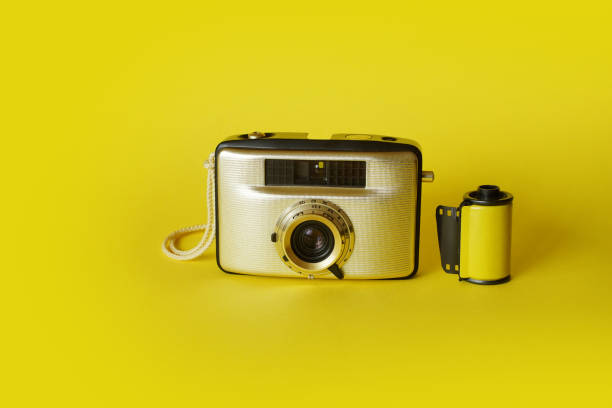 istock Vintage Film Camera And Roll On Yellow 1358054270