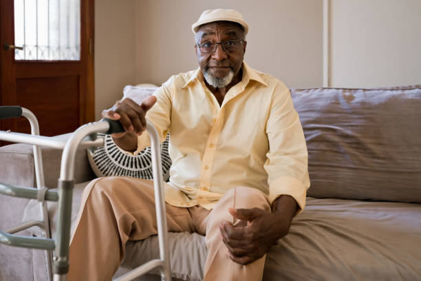 istock Senior man sitting on sofa at home 1358054926