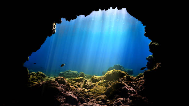 istock Rays of light at underwater cave entrance 1358055259