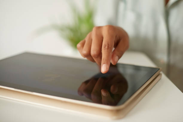 istock Shot of an unrecognizable person using a digital tablet at home 1358055472