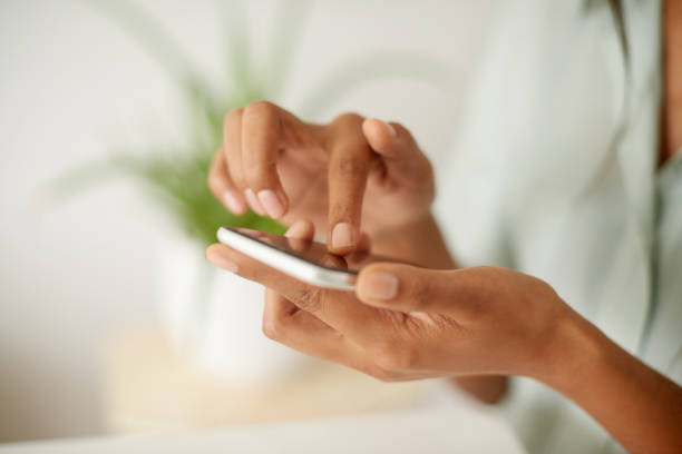 istock Shot of an unrecognizzable person using a phone at home 1358055574