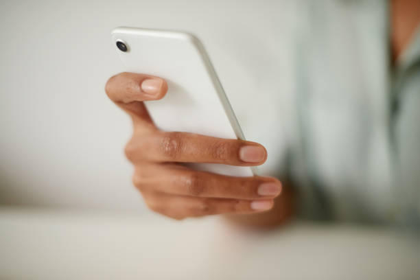 istock Shot of an unrecognizzable person using a phone at home 1358055575