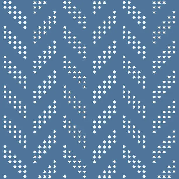 Vector illustration of Herringbone fabric seamless pattern from small white snowflakes on a light grey blue background. Christmas star and New Year halftone print background