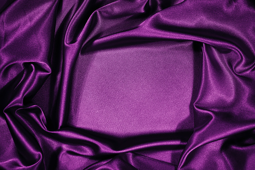 Purple silk tied bow on white background