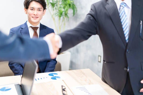 istock Business people shaking hands with smiling faces 1358058870