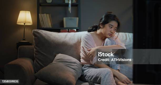 Closeup Teenager Boring While Watching Tv At Home In The Night Time Stock Photo - Download Image Now
