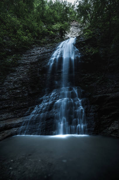 istock Waterfall in the forest at twilight. Chechen republic, Russia. 1358060590