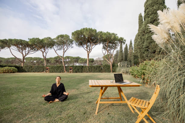 istock Girl meditating and practicing yoga on green lawn 1358061017