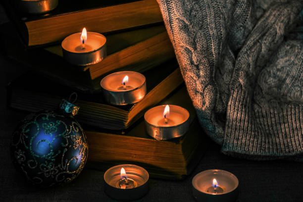 istock Burning candles and a warm knitted winter blanket 1358062979