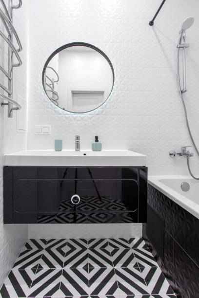 istock A modern bathroom with a black vanity, mirror, and hardware. 1358063119