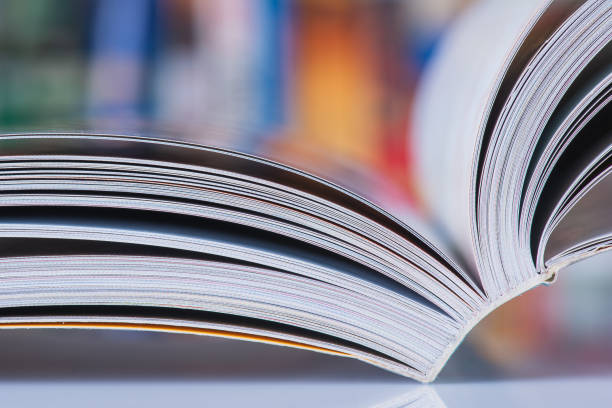 istock Opened book with blur bookshelves 1358064145