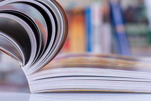 istock Opened book with blur bookshelves 1358064792