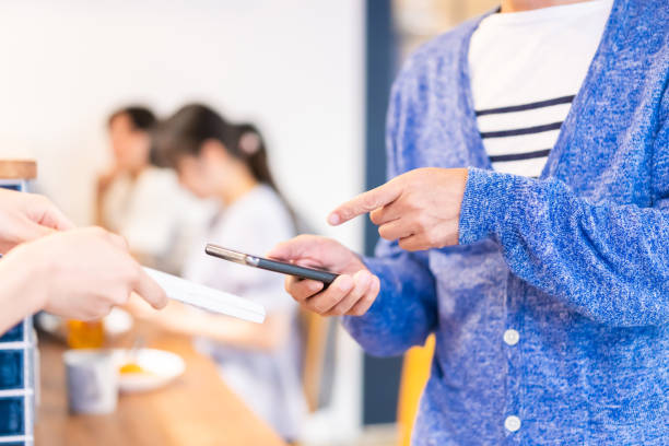 istock A gentleman makes an electronic payment at a restaurant 1358064825