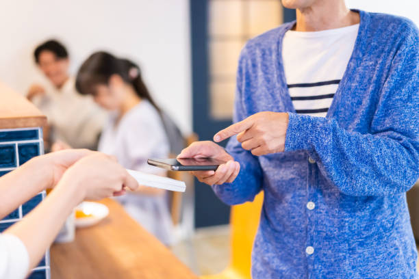 istock A gentleman makes an electronic payment at a restaurant 1358064834
