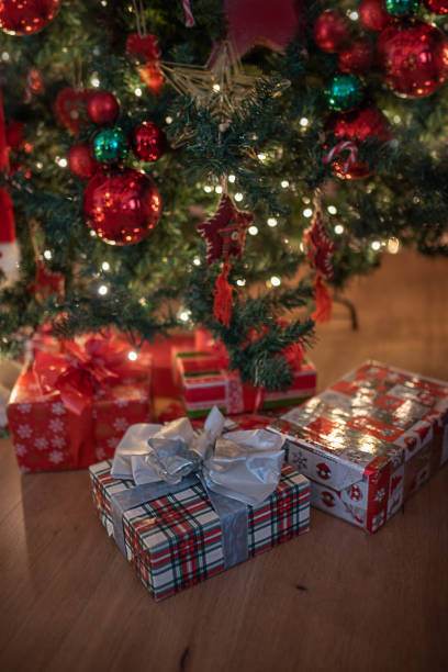 istock Gifts under fir tree. Beautiful christmas time view. 1358065028