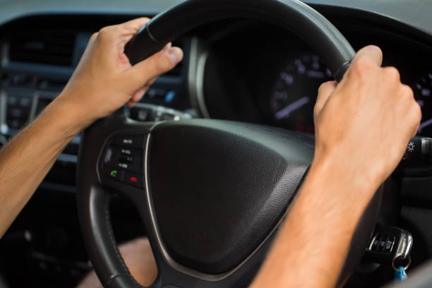 istock Hands of driving man on the road. 1358066667
