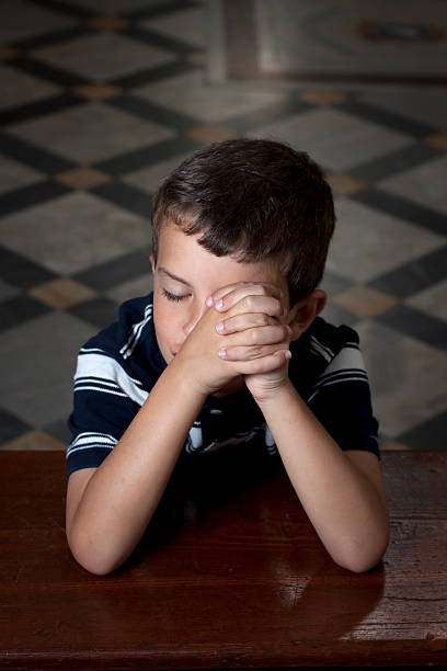 Boy praying stock photo