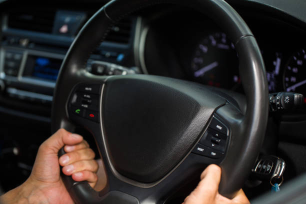 istock Hands of driving man on the road. 1358067407