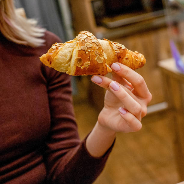 istock Woman with croissant 1358067509