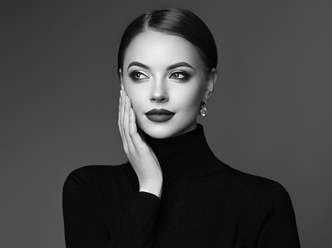 Beautiful Young Woman with Clean Fresh Skin. Perfect Makeup. Beauty Fashion. Cosmetic Eyeshadow. Girl in Black Turtleneck. Black and white photo