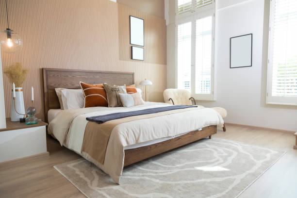istock Red and brown tone pillow in modern bedroom with blank picture frame on wall. 1358070637
