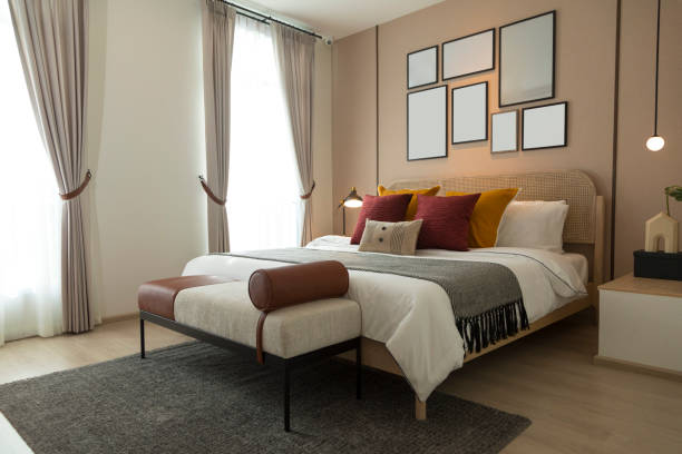 istock Red and brown tone pillow in modern bedroom with blank picture frame on wall. 1358070654