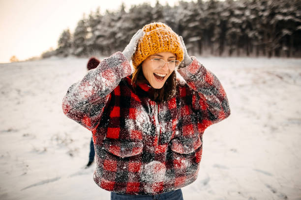 istock Winter Fun - Young Couple Having Snowball Fight 1358070751
