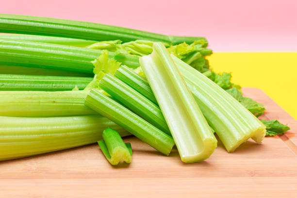 istock Fresh Celery Stem and Chopped Celery Sticks on Wooden Cutting Board 1358070804