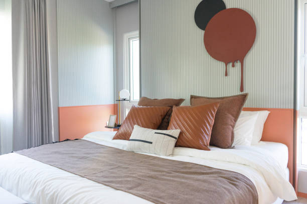 istock Modern stylish bedroom with brown and leather pillows setting. 1358071971