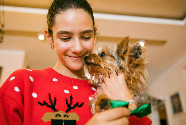 istock Christmas Time With Her Puppy 1358072025