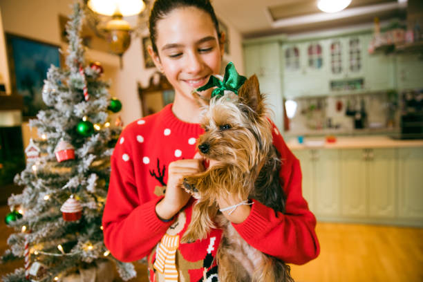 istock Christmas Time With Her Puppy 1358072035