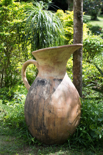 istock Old empty ceramics jug as a part of garden's decoration. Close up full frame angle view 1358073072