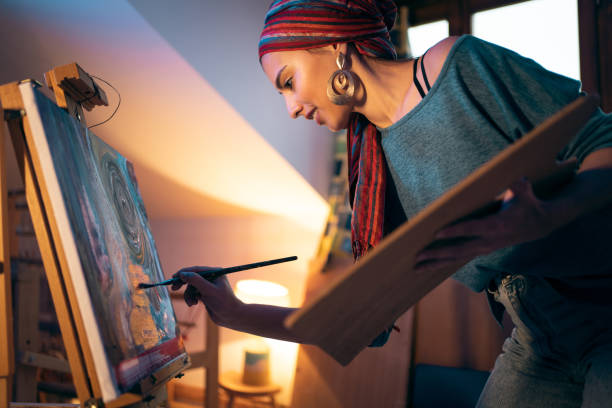 istock During night, female art student painting on canvas 1358073928