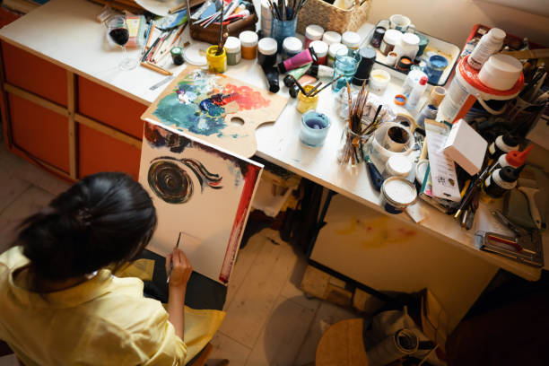 istock Unrecognizable female art student painting on canvas at art studio 1358074271