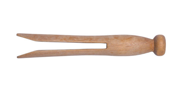Old Wooden Clothes Pin Side View Side View of Old Wood Clothes Pin Cut Out on White. clothespin wood stock pictures, royalty-free photos & images