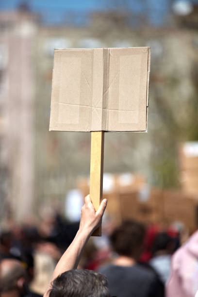 istock Protesters holding placards and signs on the streets. 1358076746