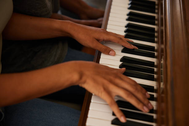 istock Young woman playing a musical composition on a piano 1358078264