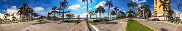 istock WEST PALM BEACH, FL - APRIL 11TH, 2018: Coastline, palms and bu - Panoramic view 1358078375
