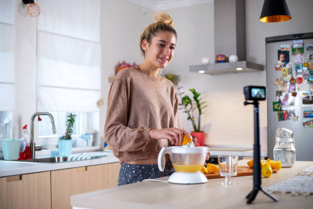 istock Young beautiful woman vlogging  and  making  fresh lemonade 1358078700