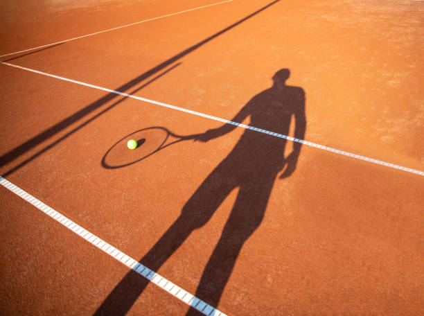 istock Shadow of a Man Playing Tennis 1358081057