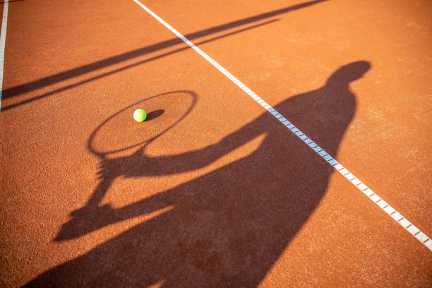 istock Shadow of a Man Playing Tennis 1358081059