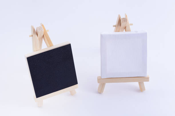 istock Two Wooden Easels Miniature with Blank Black and White Square Canvas 1358081219