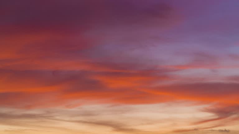 Time lapse dramatic orange sunset on dark cloudy sky