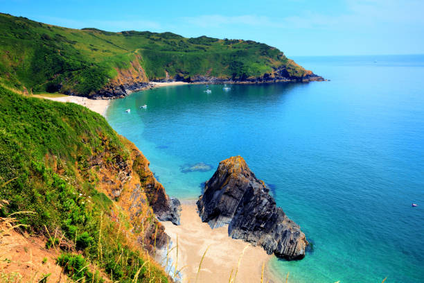 istock Lantic Bay Cornwall secluded beach with blue turquoise sea and yachts 1358082403